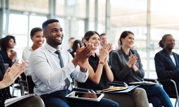 Shot of a group of businesspeople clapping during a conference